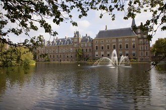 Dutch building and fountain on pond