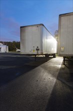 Flat bed truck trailers in parking lot
