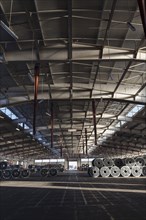 Metal rolls in warehouse