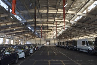New cars and vans in warehouse