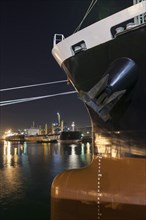 Ships moored at commercial dock at night