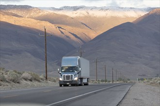 Semi-truck driving on mountain road