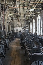 Pulleys and machinery in empty old-fashioned factory