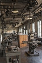 Pulleys and machinery in empty old-fashioned factory