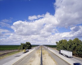 Cars and semi-trucks driving on freeway