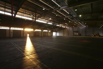 Light from doorway in vacant warehouse