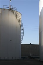 Staircase curving around storage tank