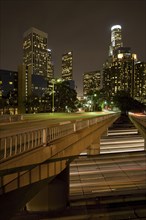 Bridge over lights on urban highway at night