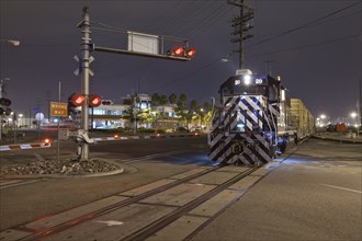 Train at railroad crossing at night