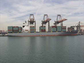Cranes above cargo containers on freighter