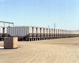 Row of cargo containers on semi-trucks