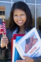 Asian woman holding voting binder