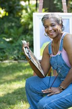 Black artist painting outdoors