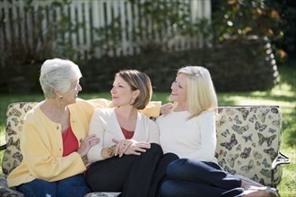 Three generations of Caucasian women relaxing outdoors