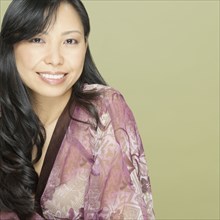 Studio shot close up of Asian woman smiling