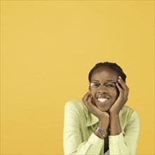 Studio shot of African woman wearing eye glasses and smiling