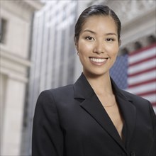 Asian businesswoman in front of American flag
