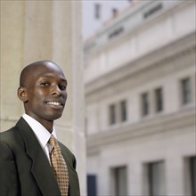 Portrait of African businessman in front of building