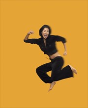 Blurred motion shot of Asian woman jumping
