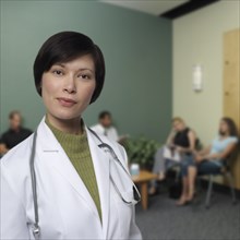 Mixed race doctor standing in waiting room