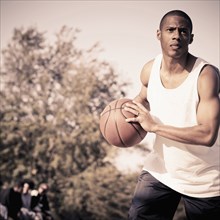 African American man playing basketball on court