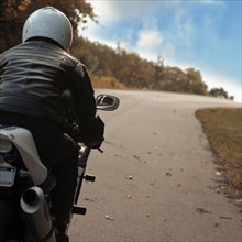 Man riding motorcycle on rural road