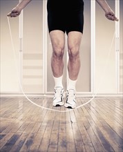 Man jumping rope indoors