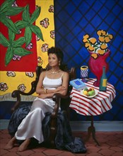African American woman sitting at still life wall art