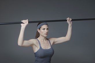 Mixed race woman lifting weights