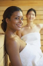 Two multi-ethnic women relaxing in sauna
