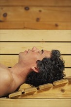 Man relaxing in sauna