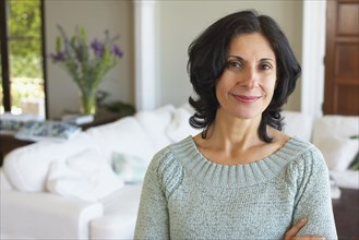 Confident Middle Eastern woman in living room