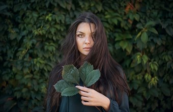 Caucasian woman holding leaves