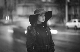 Caucasian woman wearing hat and coat in city