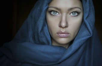 Caucasian woman wearing blue headscarf