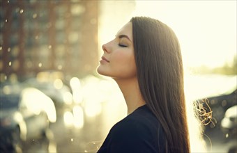 Profile of Caucasian woman outdoors with eyes closed