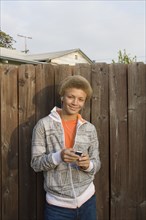 Mixed race boy listening to mp3 player