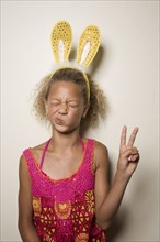 Mixed race girl with bunny ears