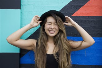 Asian woman smiling with eyes closed