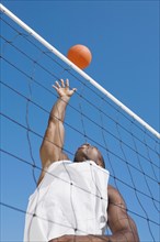African man playing volleyball