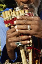 Close up of African man playing pan flute