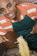 African man serving spaghetti