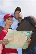 Hispanic couple looking at map