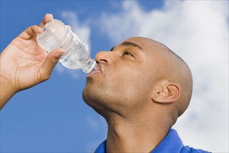 African man drinking water
