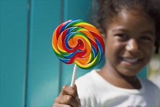 African girl holding lollipop