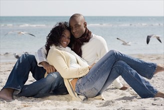 Multi-ethnic couple hugging at beach