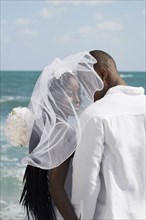 African bride and groom at beach
