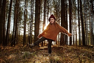 Caucasian girl standing in forest