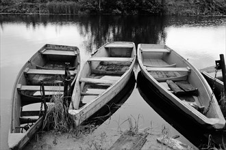Empty wooden canoes on river
