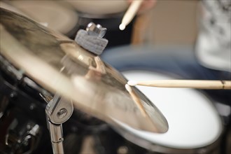 Close up of drumsticks hitting cymbals